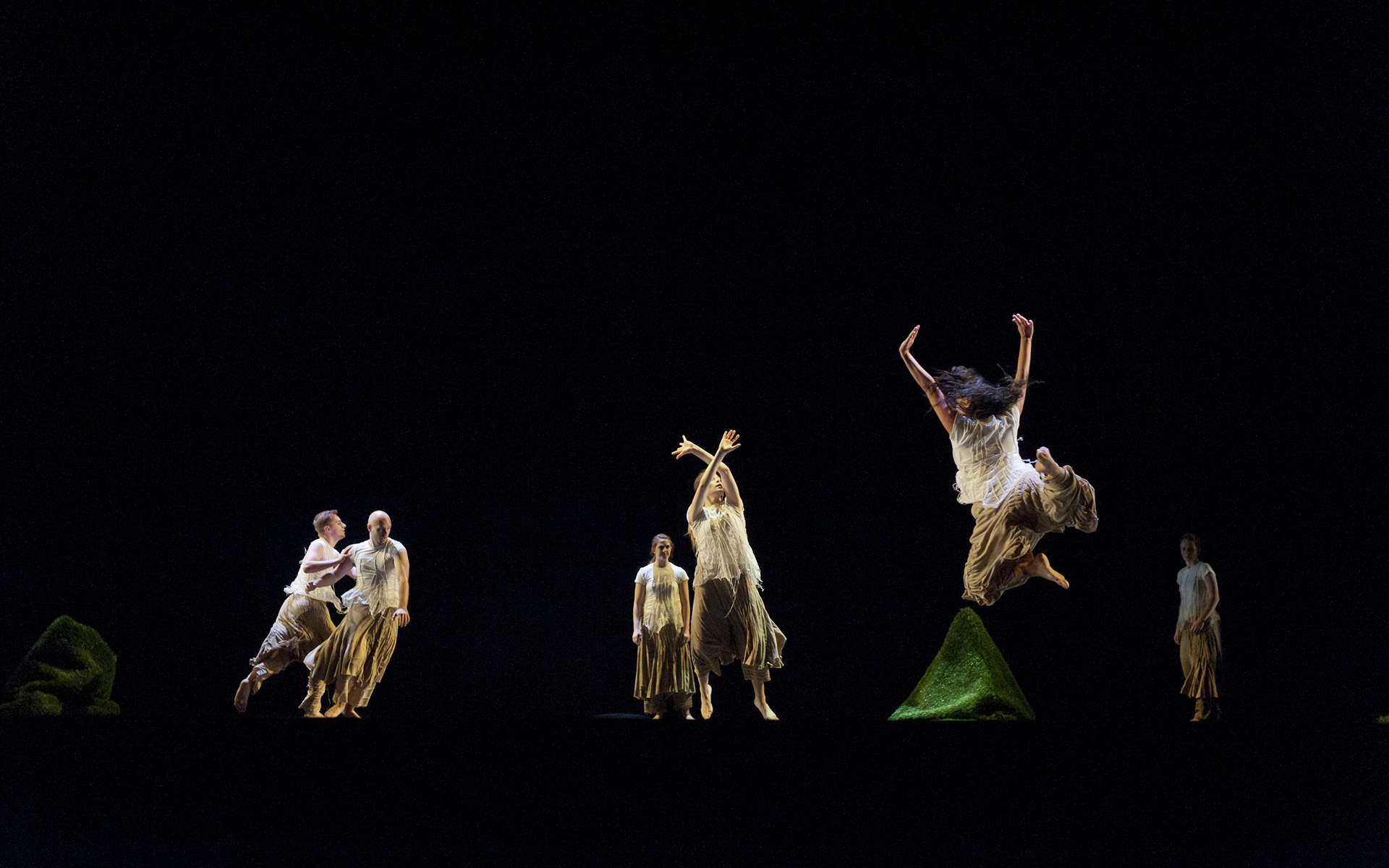 Dance Gala 2017 photo. Female dancer jumping, other dancers leaning.