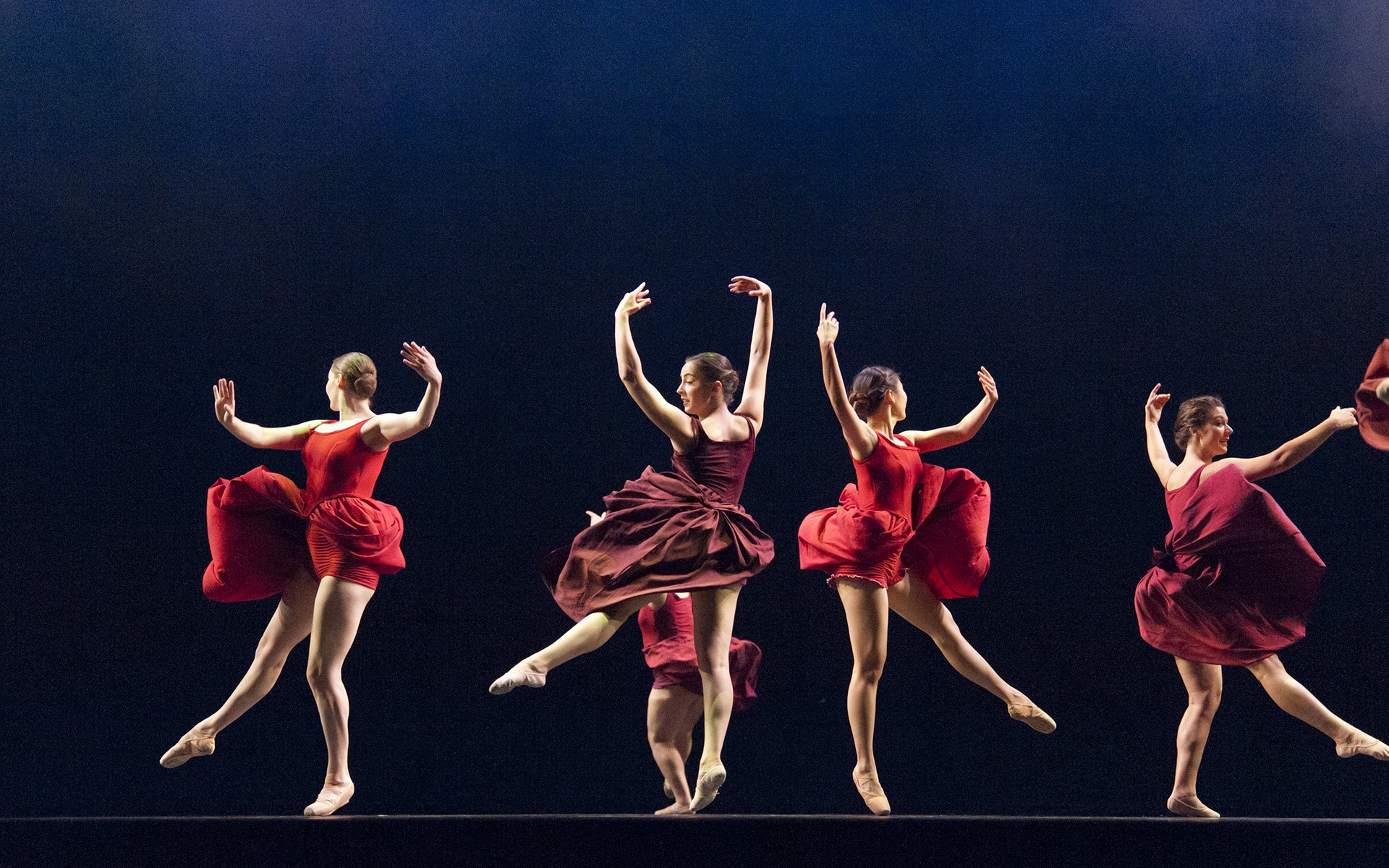Dance Gala 2017 photo. Four female dancers in red dresses, ballet.