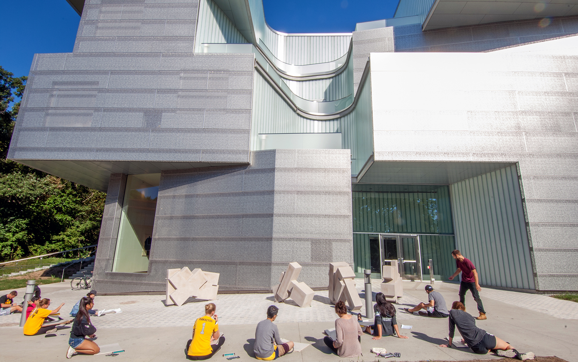 Students perfecting their artistic skills outside the new Visual Arts Building.