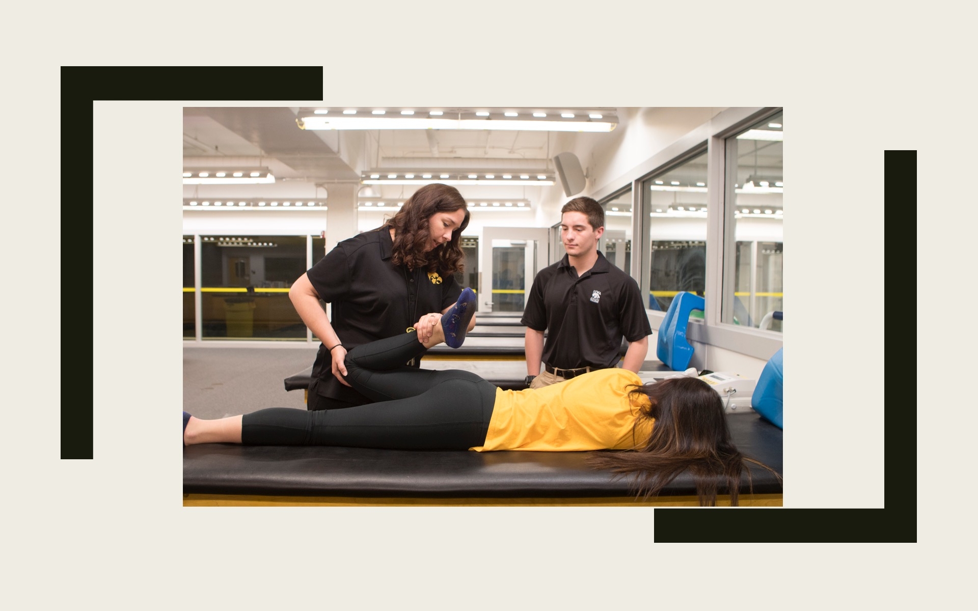 Faculty demonstrating a supine quadricep stretch to a student